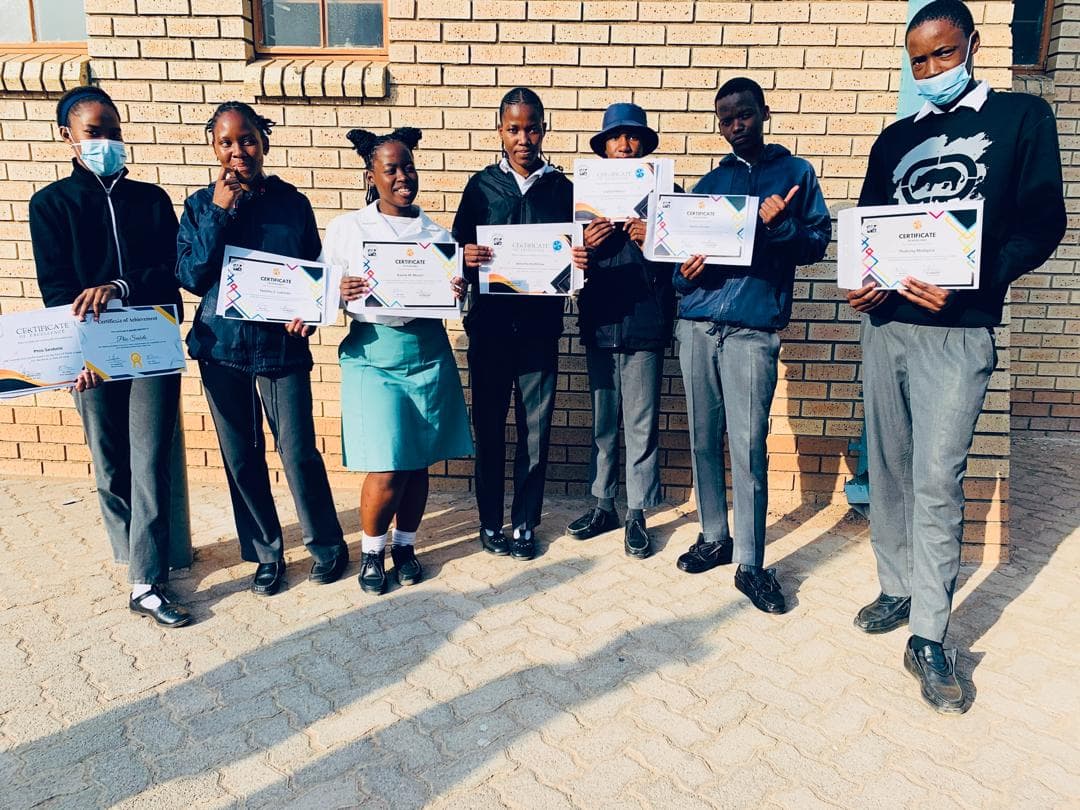 Students holding certificates