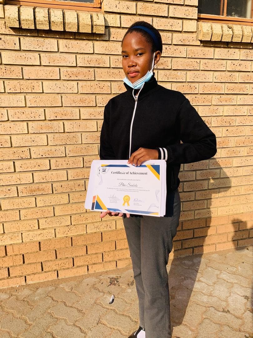 Student holding certificate
