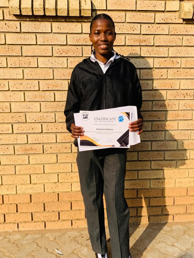Student holding certificate